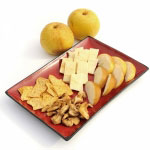 dried asian pears, cheese, crackers on a red platter with 2 fresh whole Asian Pears